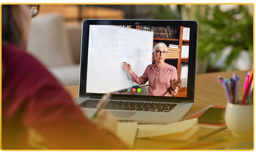 Person watching an online lecture on a laptop at home.
