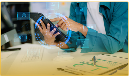 Person using a digital tablet with virtual interface icons surrounding it in an office setting.