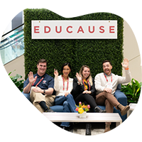 group of people sitting under an EDUCAUSE sign