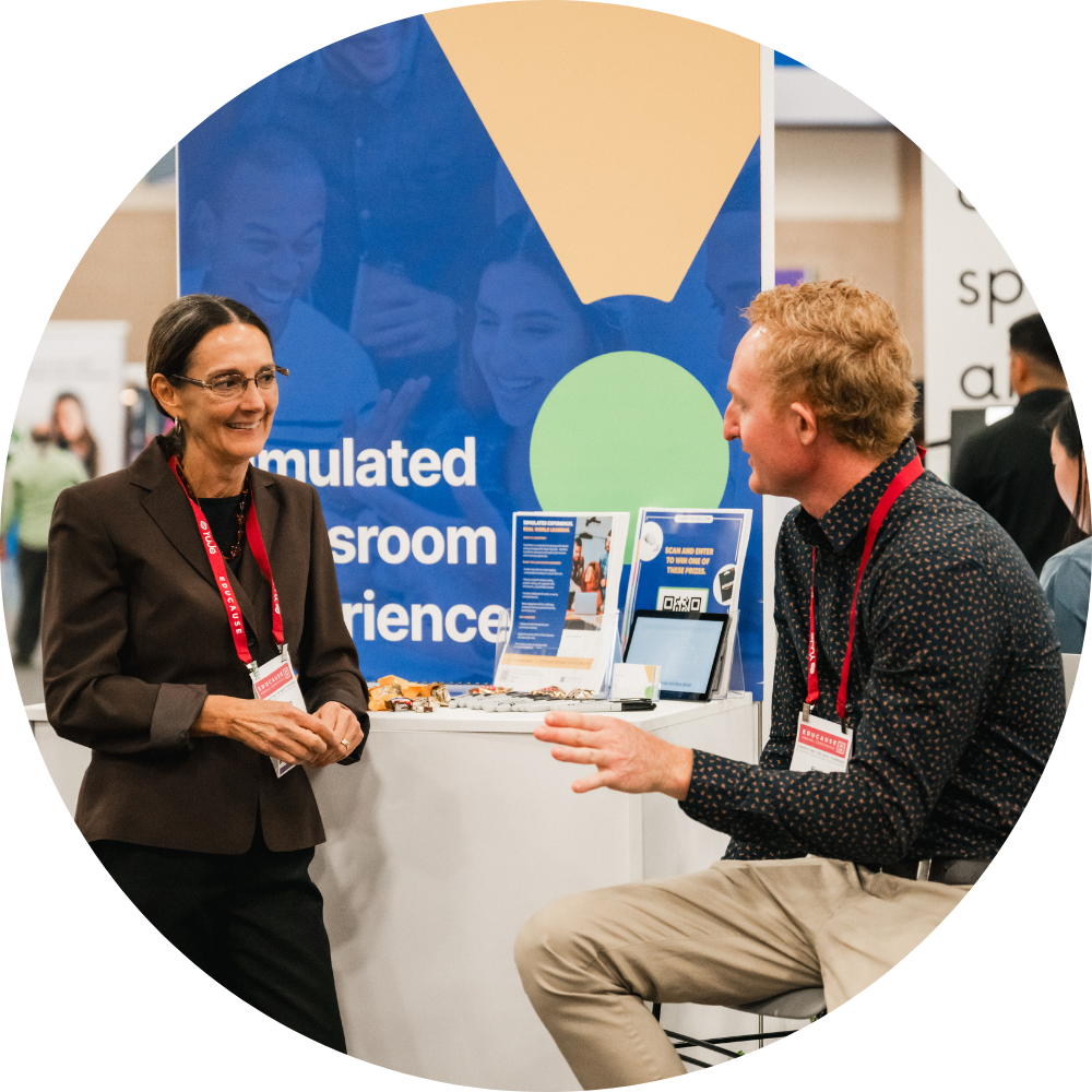 2 people talking at an Emerging Tech Experience display