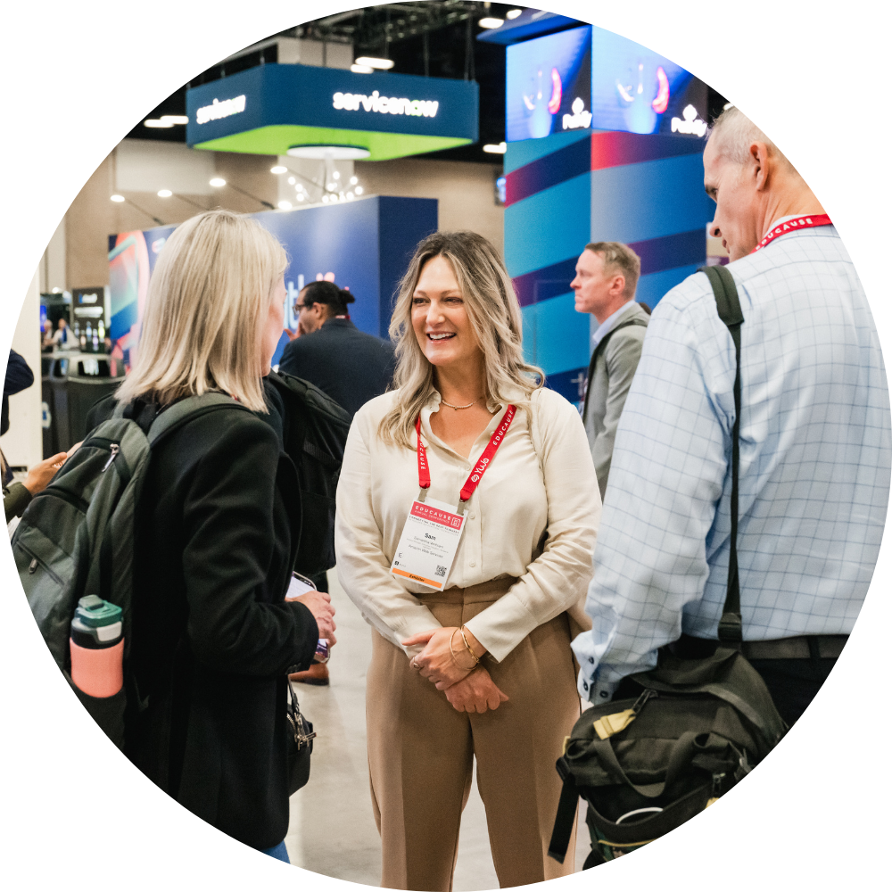 3 people talking in the exhibit hall
