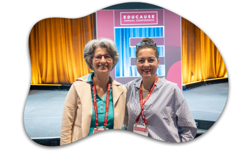 2 attendees in front of a stage