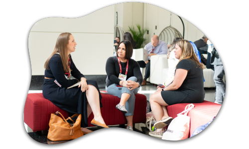 3 attendees sitting and talking