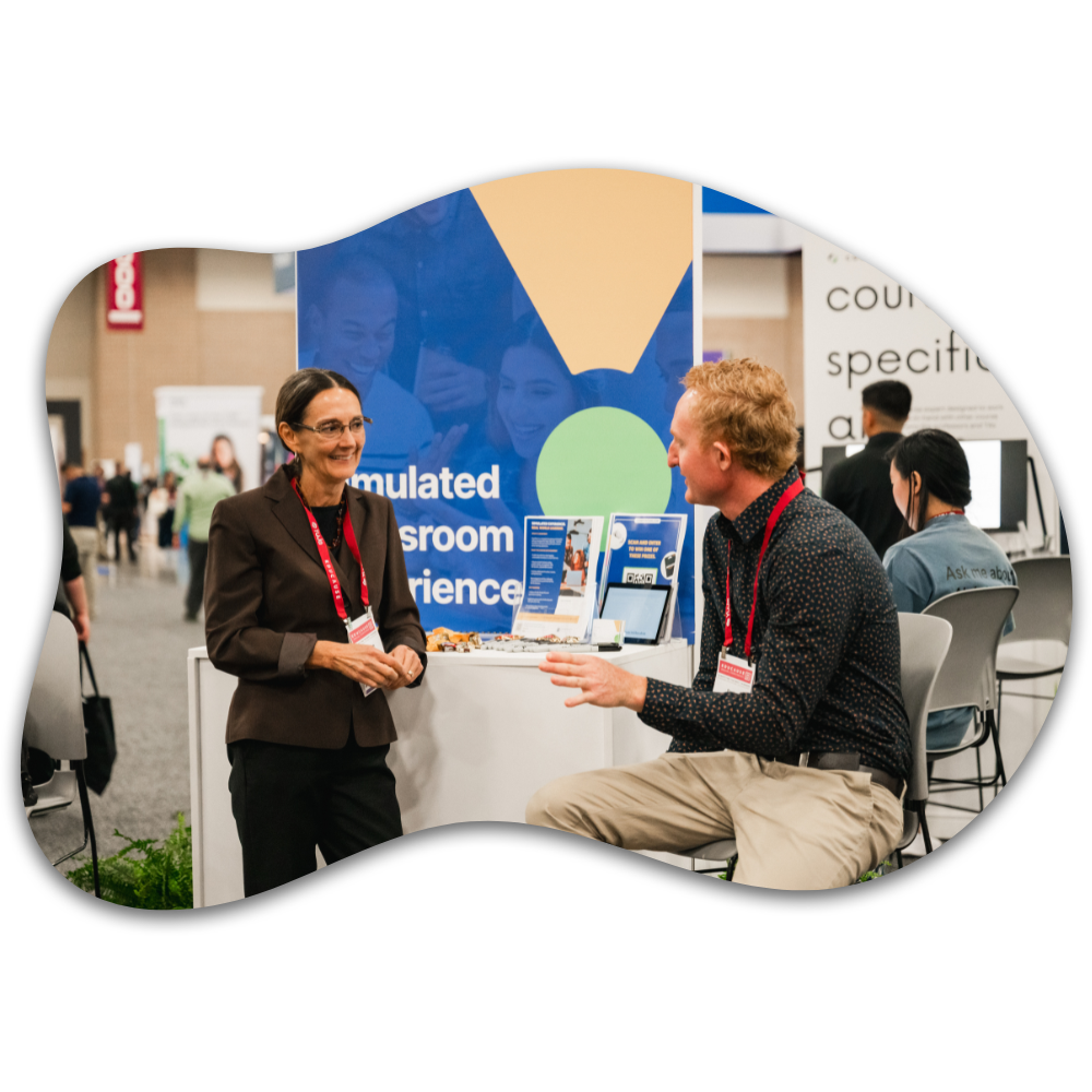 2 people talking at an Emerging Tech Experience display