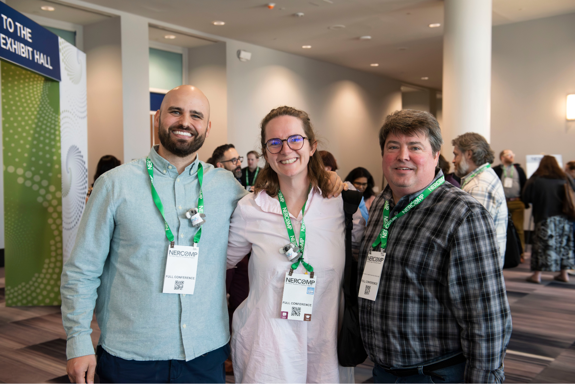 3 Conference Attendees in front of Exhibit Hall