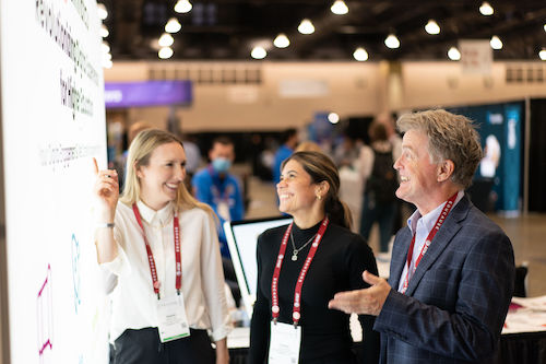 3 people looking at a display